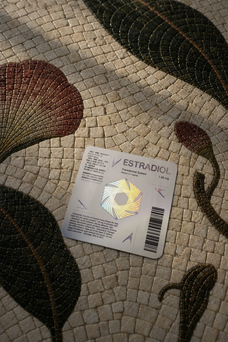 Estradiol pouch resting on a bird mosaic